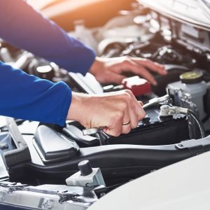 hands-of-car-mechanic-with-wrench-in-garage-KA3UEHD.jpg